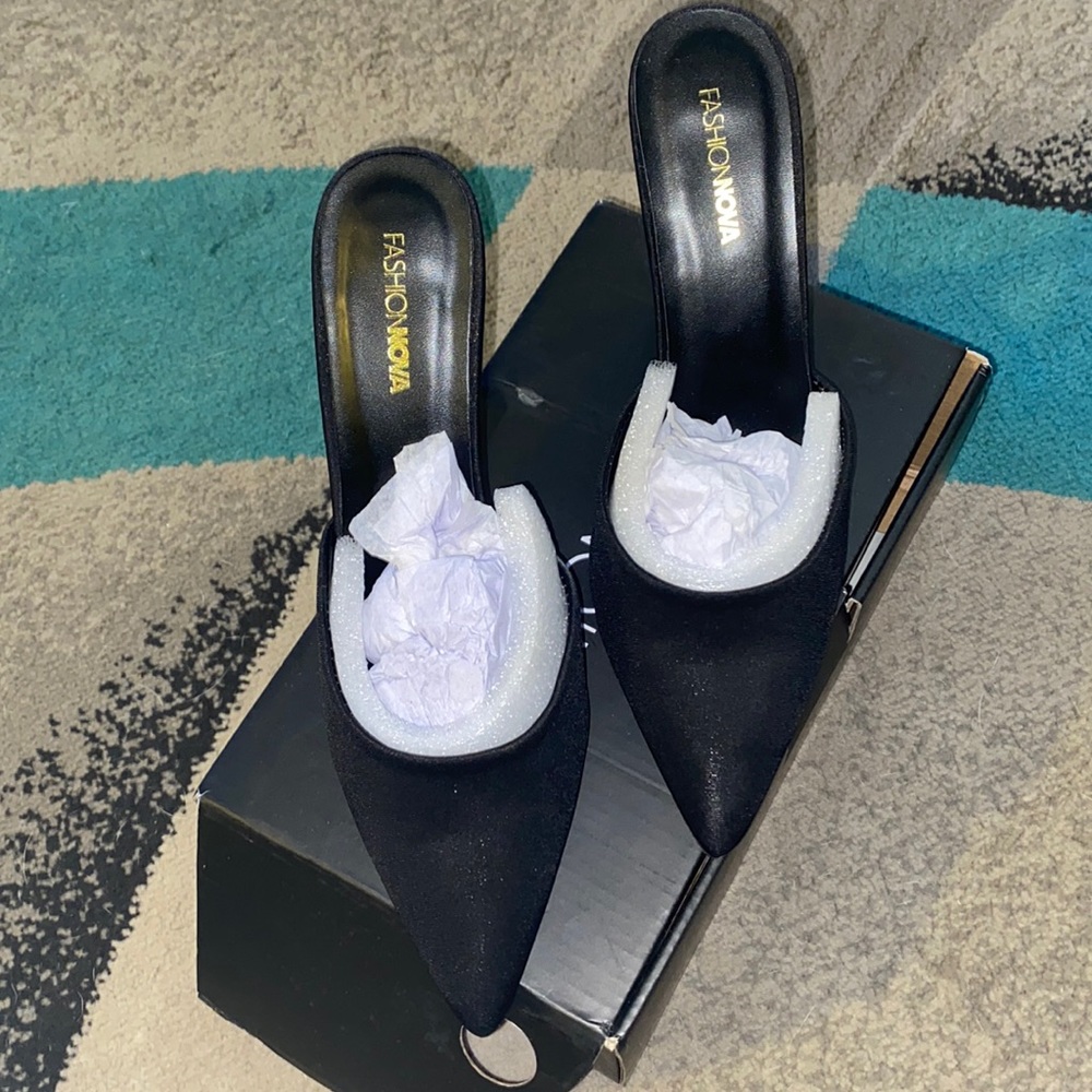 Black slide on mules. Pearl accent on heel. Size 9. 3 inch heel.